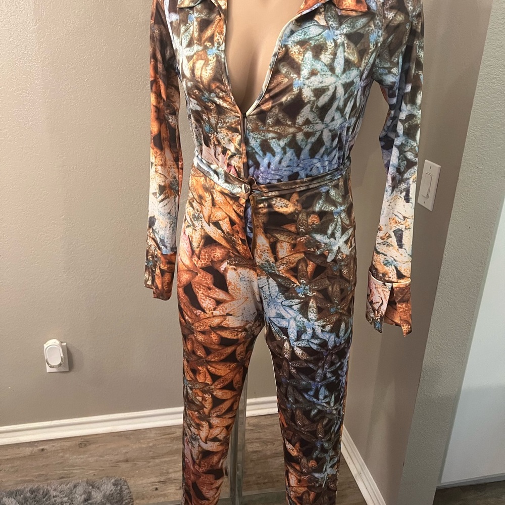 Multi colored jumpsuit never worn I broke zipper trying on